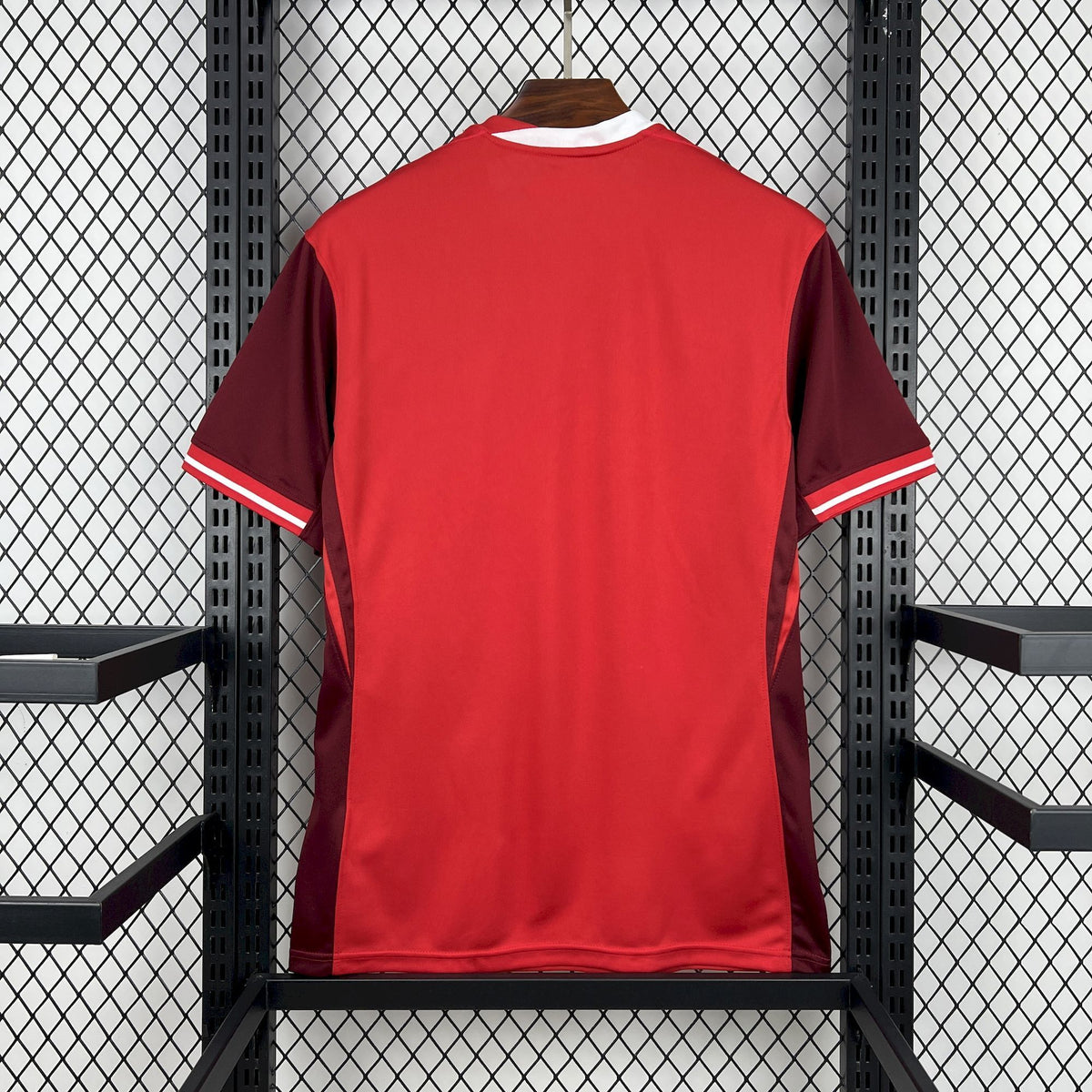 Red Canada soccer jersey with white side sleeve stripes, back view.