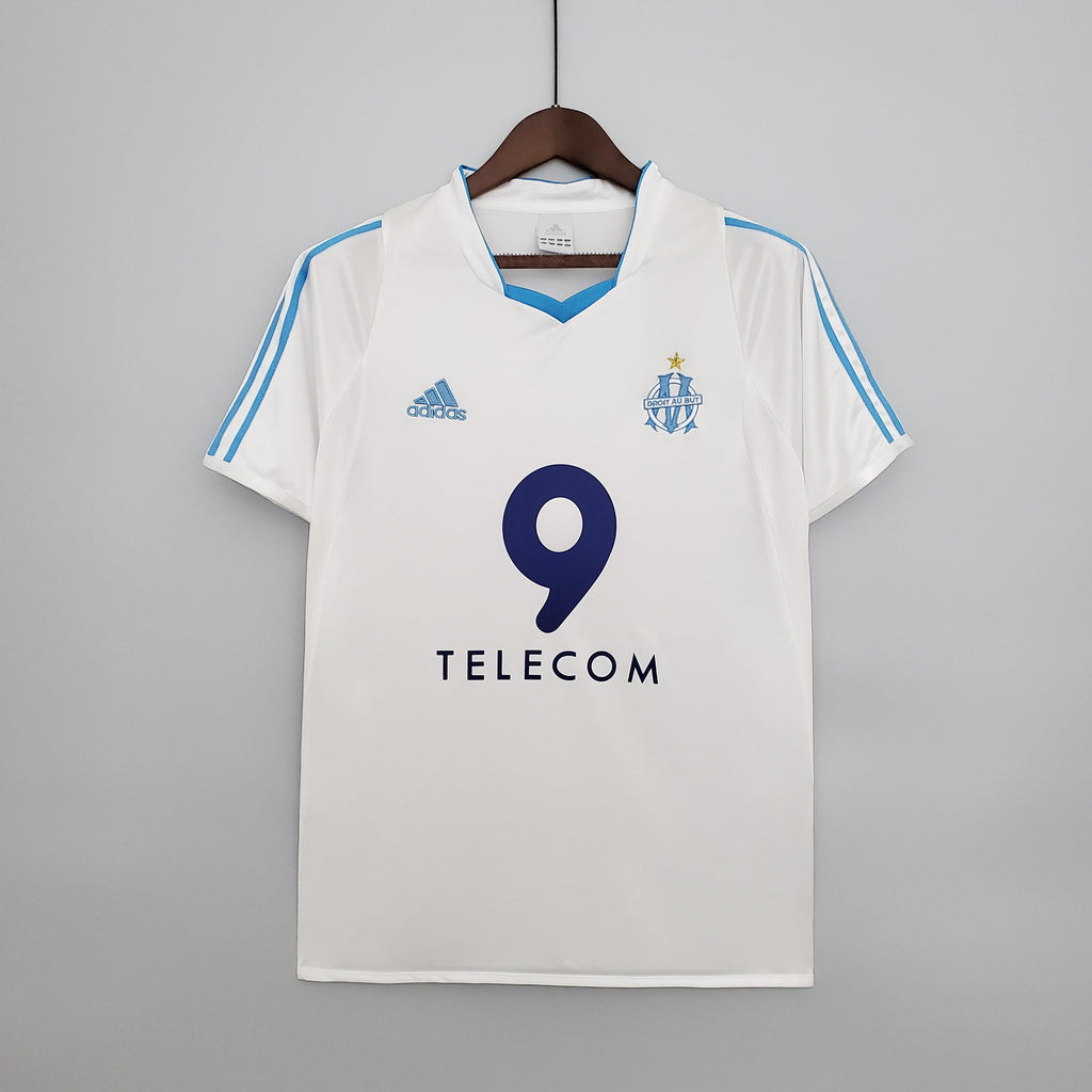 White retro home football jersey with blue V-neck, number 9, and TELECOM sponsor
