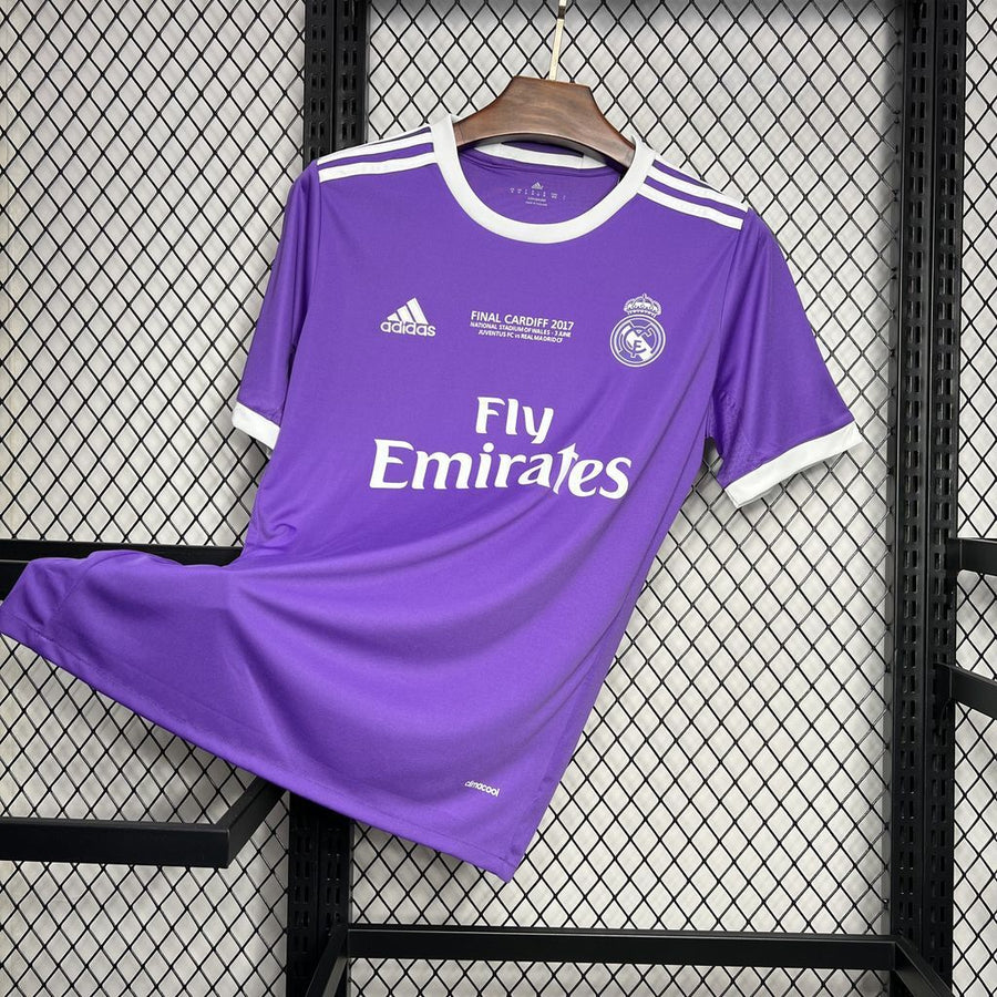 Purple soccer jersey with Fly Emirates sponsor, adidas logos, and Real Madrid crest.