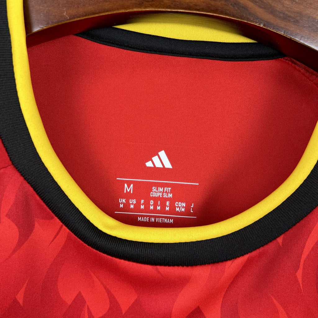 Red jersey neck inside label with yellow trim and "adidas" logo