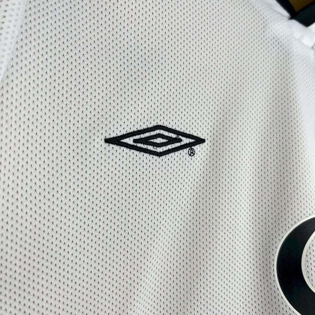 Umbro diamond logo on white textured football jersey fabric