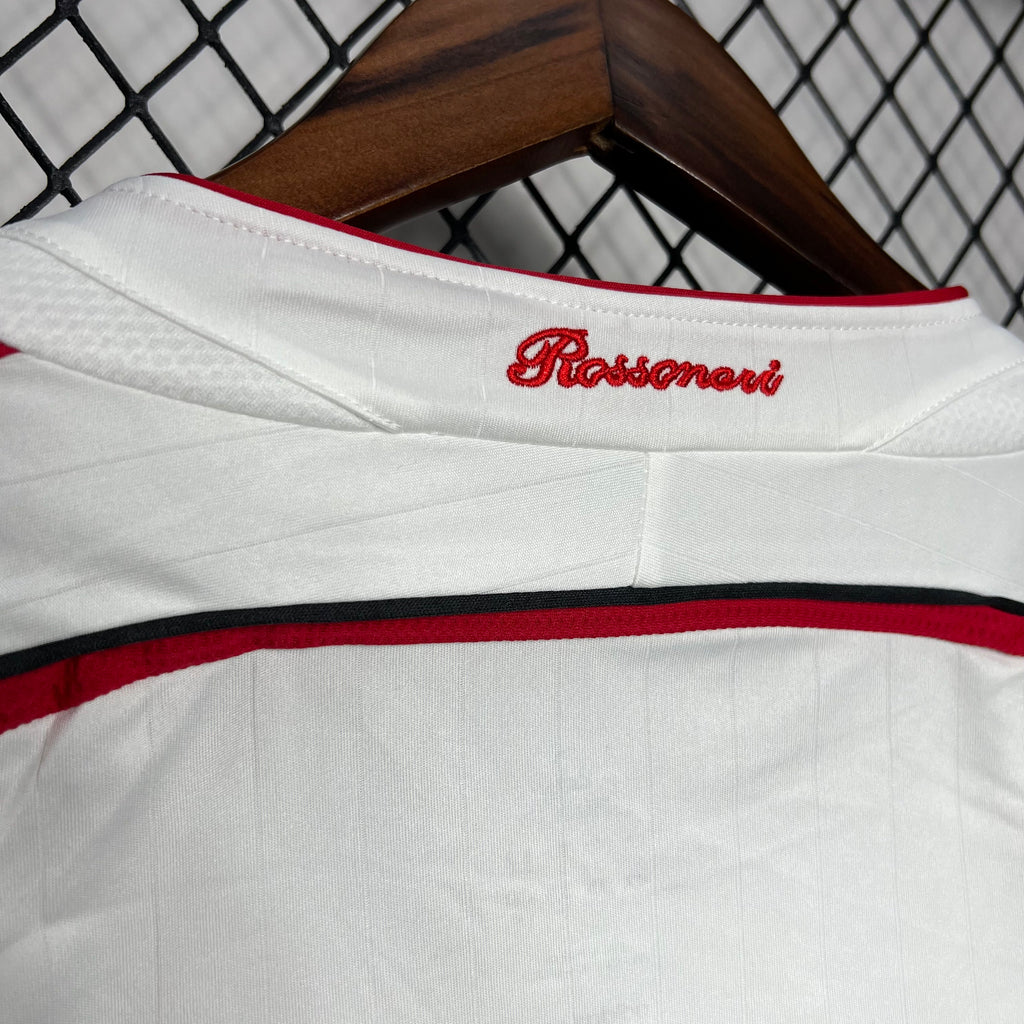 White away soccer jersey neckline with red script logo on the collar
