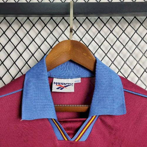 Maroon retro football jersey with blue collar and Reebok neck label