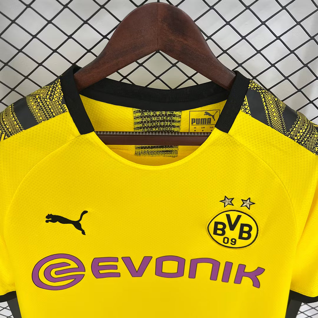 Yellow football jersey close-up with Evonik logo, Puma mark, and BVB crest