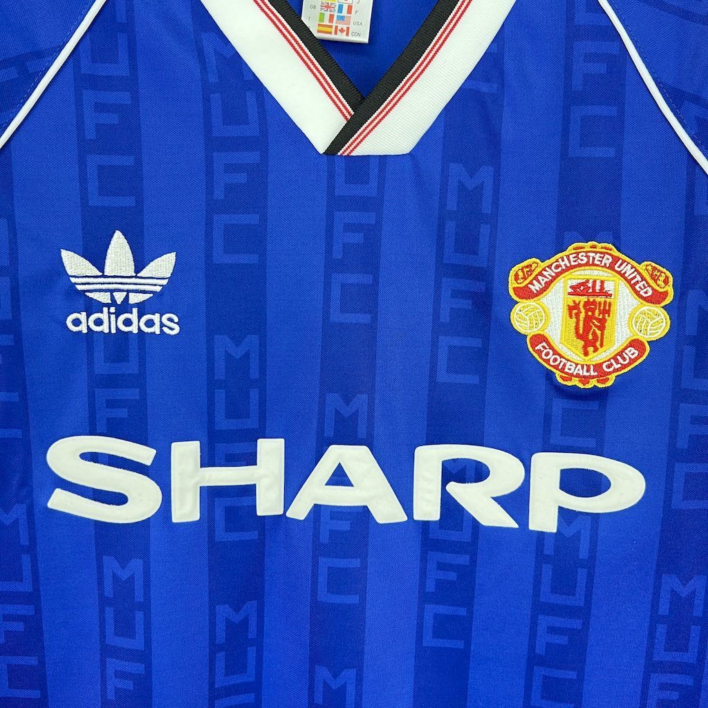 Blue retro football shirt with adidas logo and SHARP sponsor text