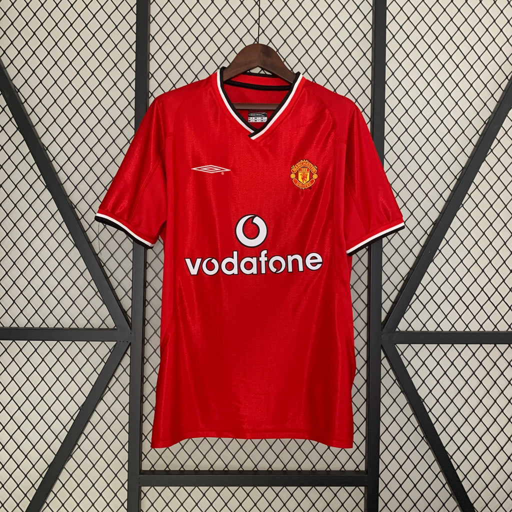 Red home football shirt with V-neck trim, Vodafone sponsor and club crest