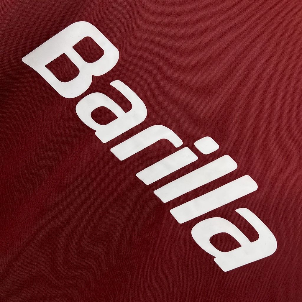 Barilla white sponsor text on maroon football jersey