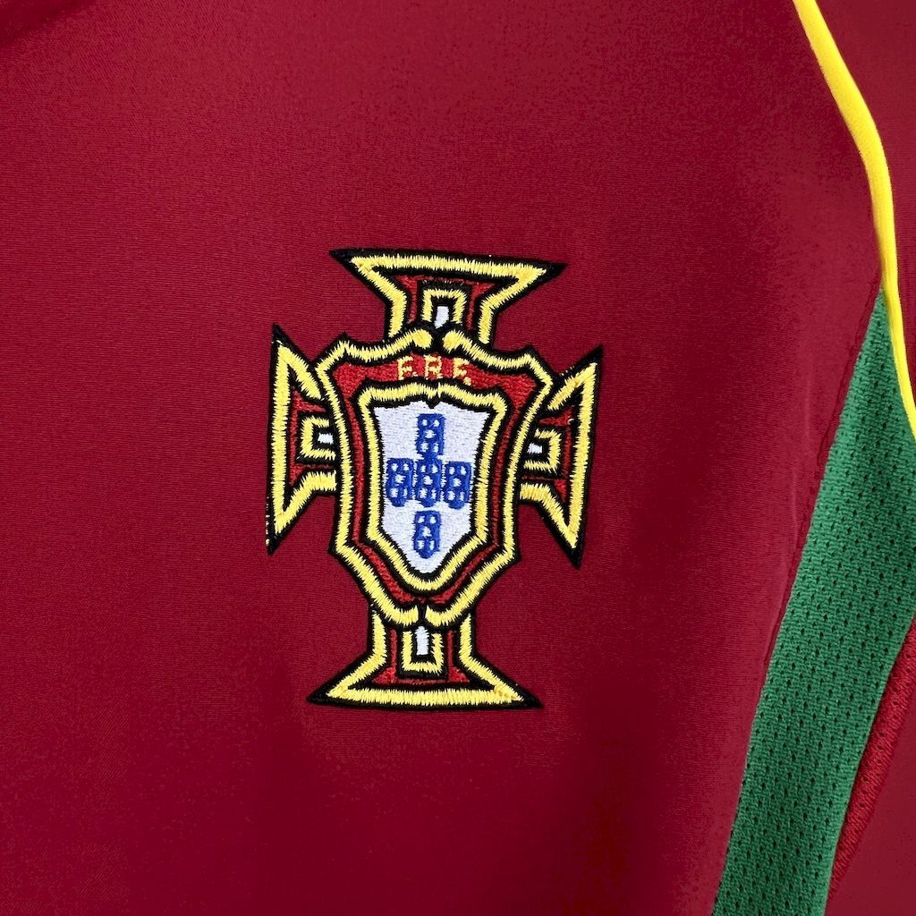 Portugal crest patch on red football shirt with yellow outline and gold trim