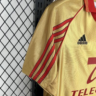 Yellow soccer jersey sleeve with red stripes and Adidas logo