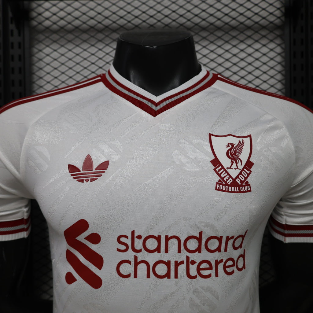 Liverpool FC away jersey front, white with red crest and standard chartered sponsor