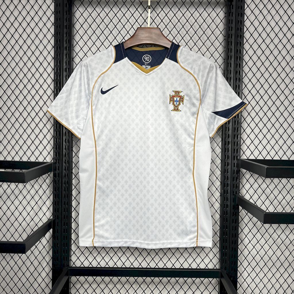 White Portugal away soccer jersey with navy collar and gold trim, front crest and Nike logo