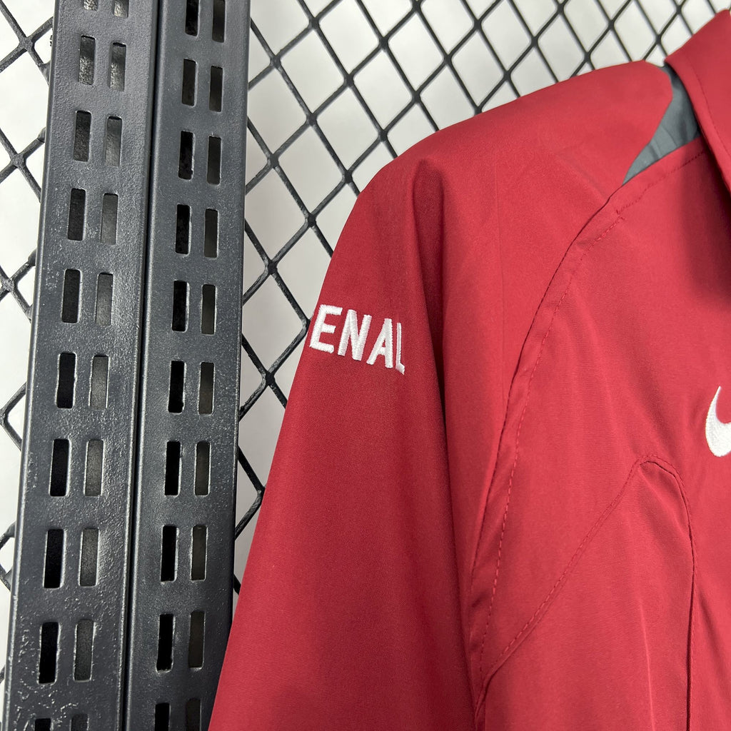 Red windbreaker jacket sleeve with ENA/LI text detail and curved seam