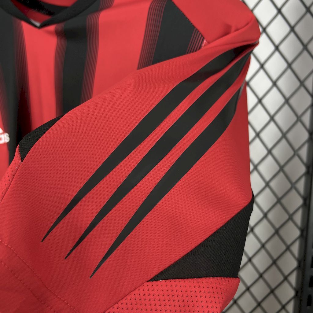 Red-and-black jersey shoulder with diagonal stripe detail and stitched trim