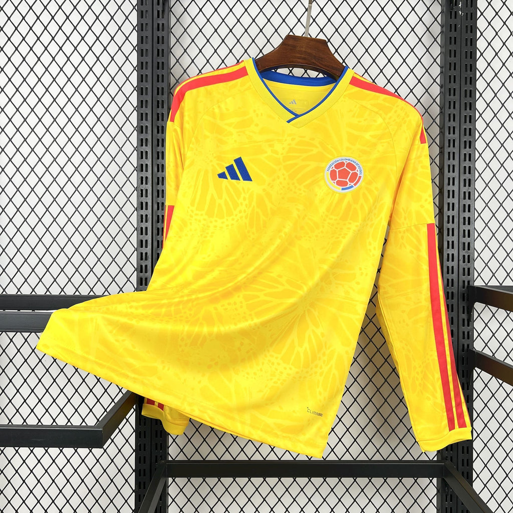 Yellow Colombia home soccer jersey with blue trim and red side stripes, long sleeves.