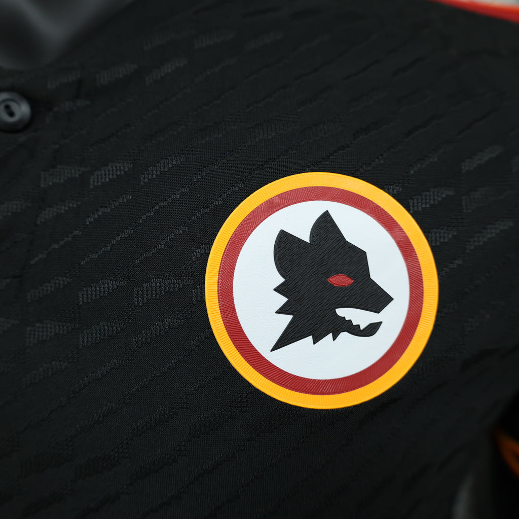 Roma third football jersey, close-up of club crest patch on black jersey