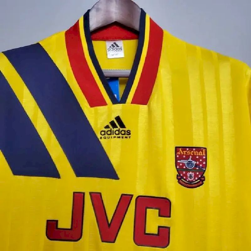 Yellow retro football jersey front with adidas logo, Arsenal crest, V-neck collar and JVC