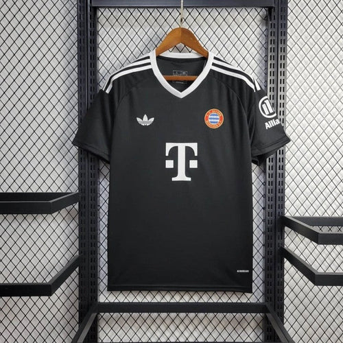Black goalkeeper soccer jersey with V-neck, white shoulder stripes, Bayern crest, T sponsor