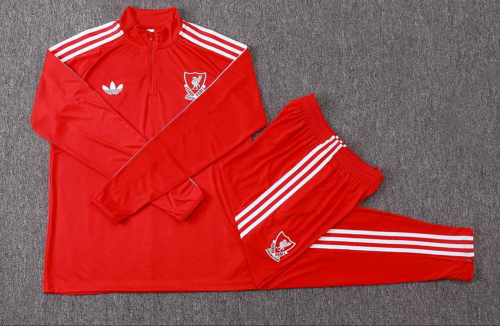 Red 1/4-zip training top and track pants set with white side stripes and crests.