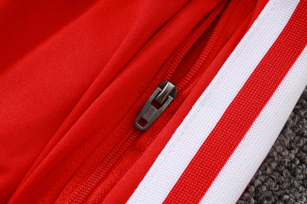 Red 1/4-zip placket with dark zipper pull and white stripe trim along the seam.