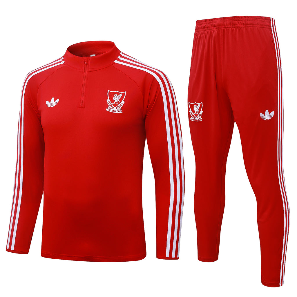 Red 1/4-zip training top and matching track pants with white stripes and club logos.