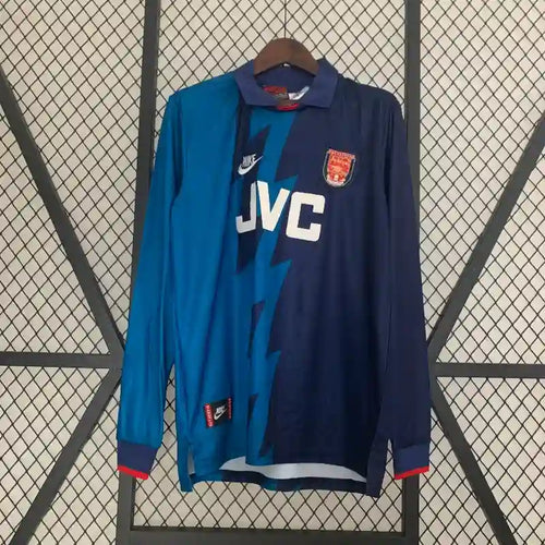 Retro soccer jersey with Arsenal crest, JVC sponsor, blue and dark navy long sleeves.