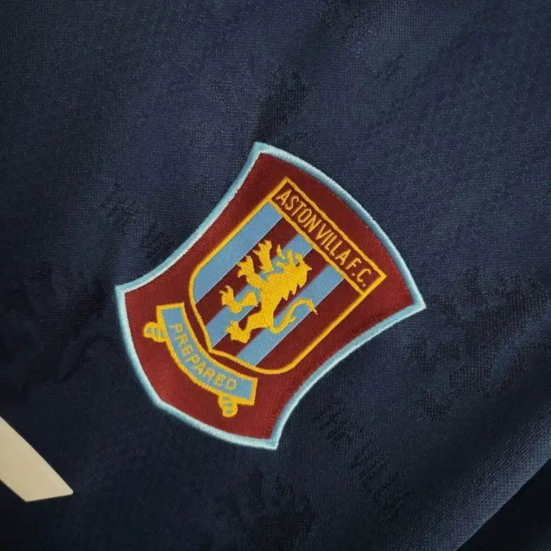 Aston Villa crest patch on dark blue football shirt fabric