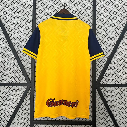 Yellow retro football jersey back with navy collar and 'Gunners' sponsor text