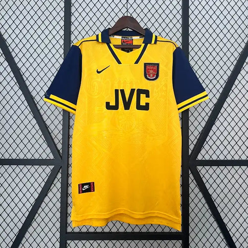 Yellow Arsenal away retro football jersey with navy collar and sleeve trim