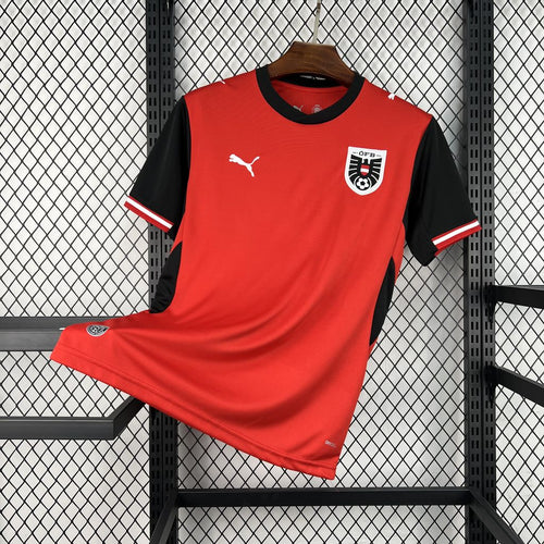 Red home football jersey with black sleeves and Puma logo, front view
