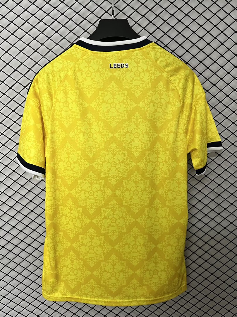 Yellow Leeds away fan jersey with black collar trim and 'LEEDS' text on back