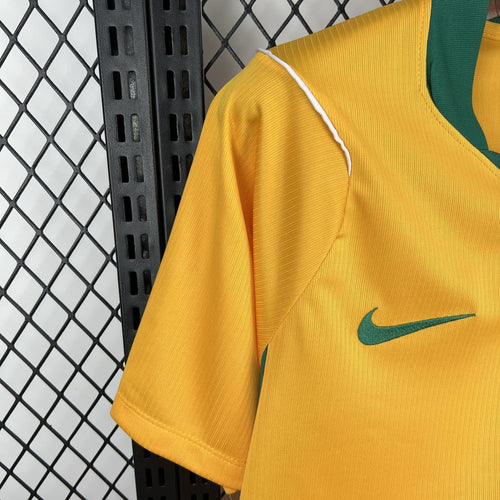 Yellow short-sleeve soccer jersey, green collar, Nike swoosh on sleeve