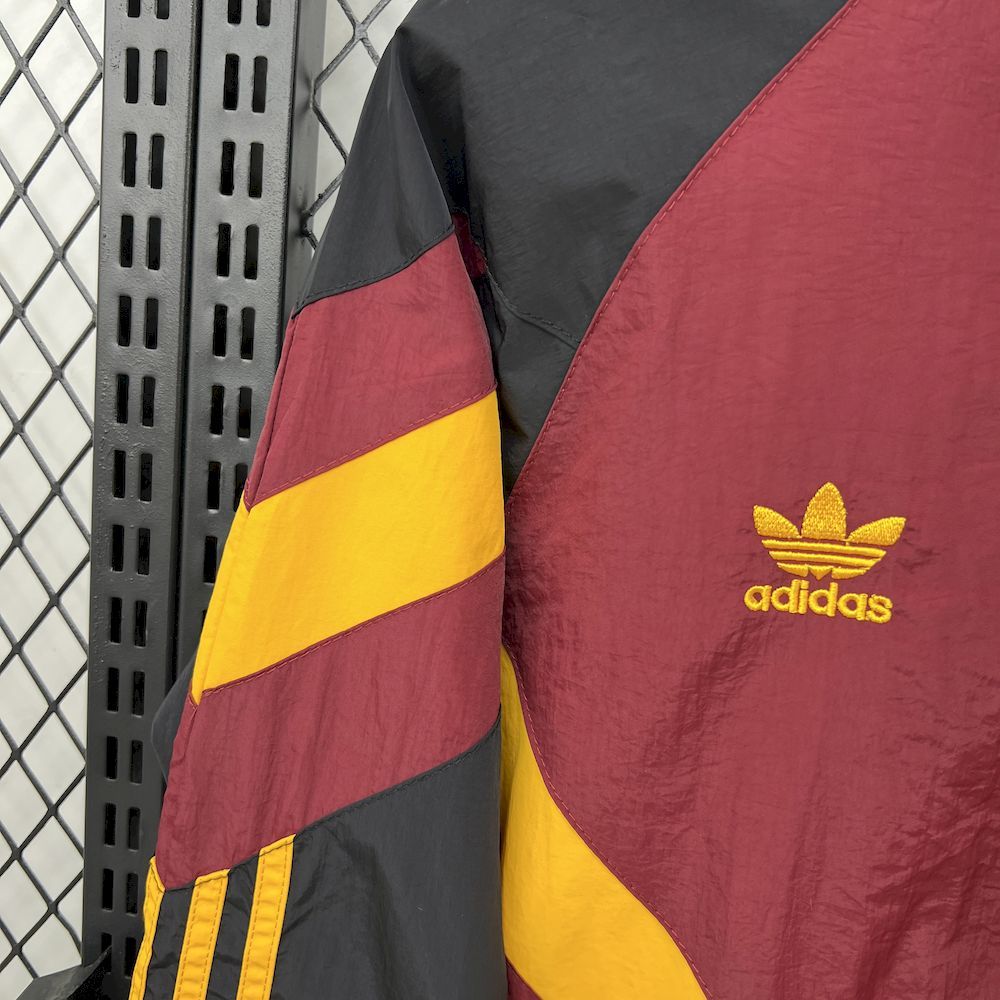 Maroon windbreaker sleeve with black and yellow diagonal stripes, ribbed cuff detail.