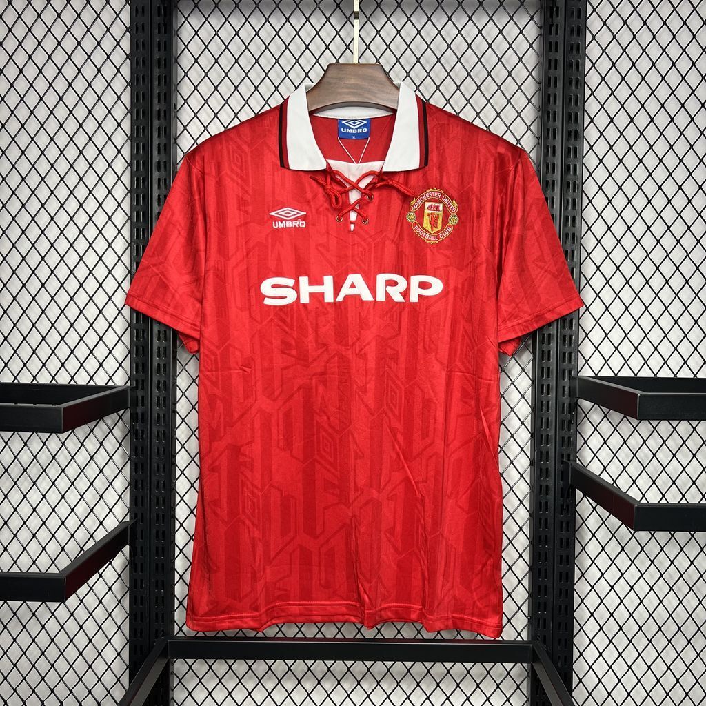 Red Manchester United-style home football jersey with white collar and SHARP sponsor logo