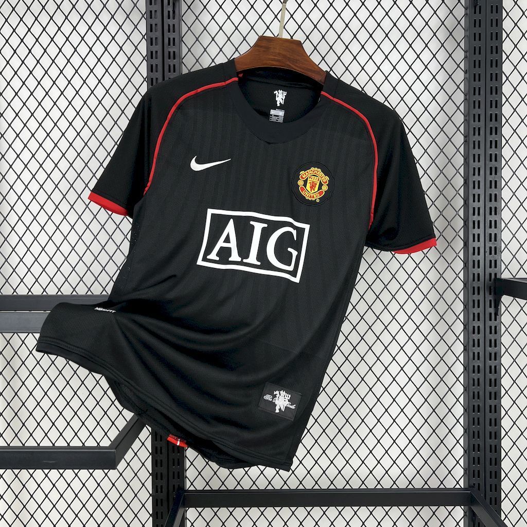 Retro away football jersey, black with red trim; crest and AIG sponsor on front