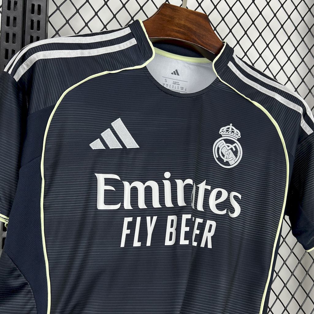 Dark navy Real Madrid away fan jersey close-up with Emirates Fly Better and club crest