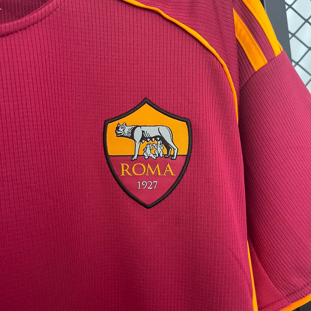Maroon soccer jersey with Roma 1927 shield and yellow trim at neckline