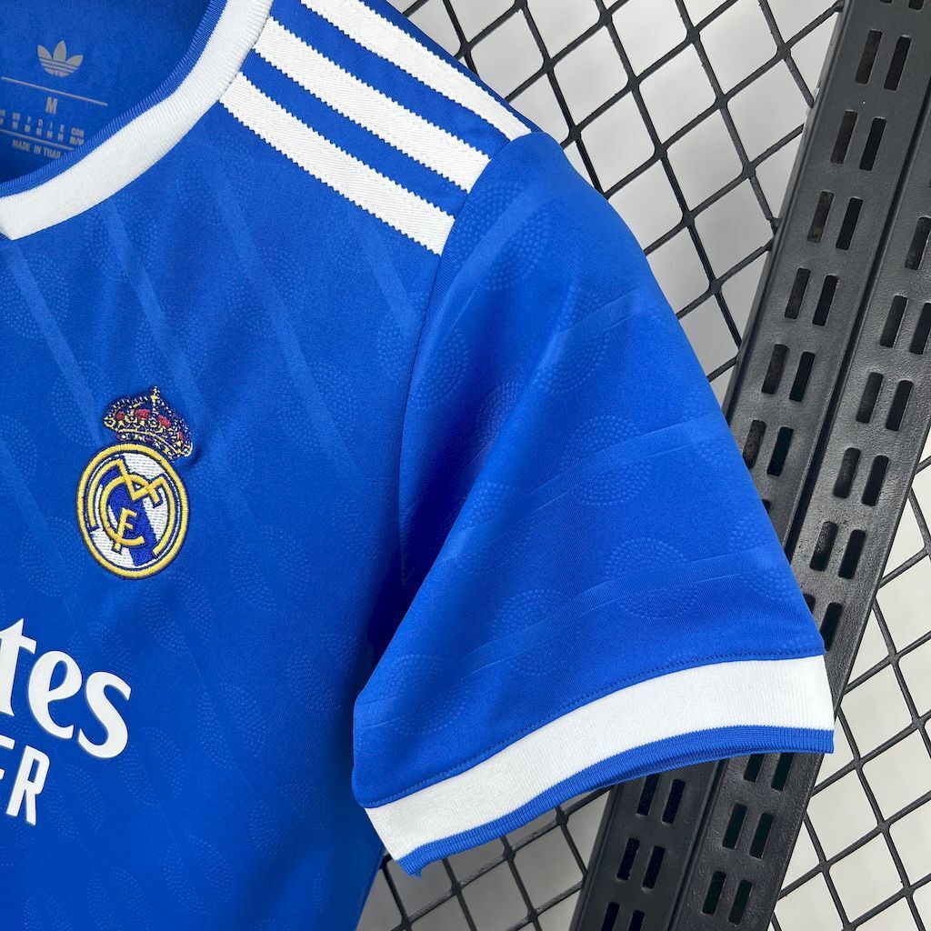 Blue soccer jersey sleeve with club crest and white striped cuff trim