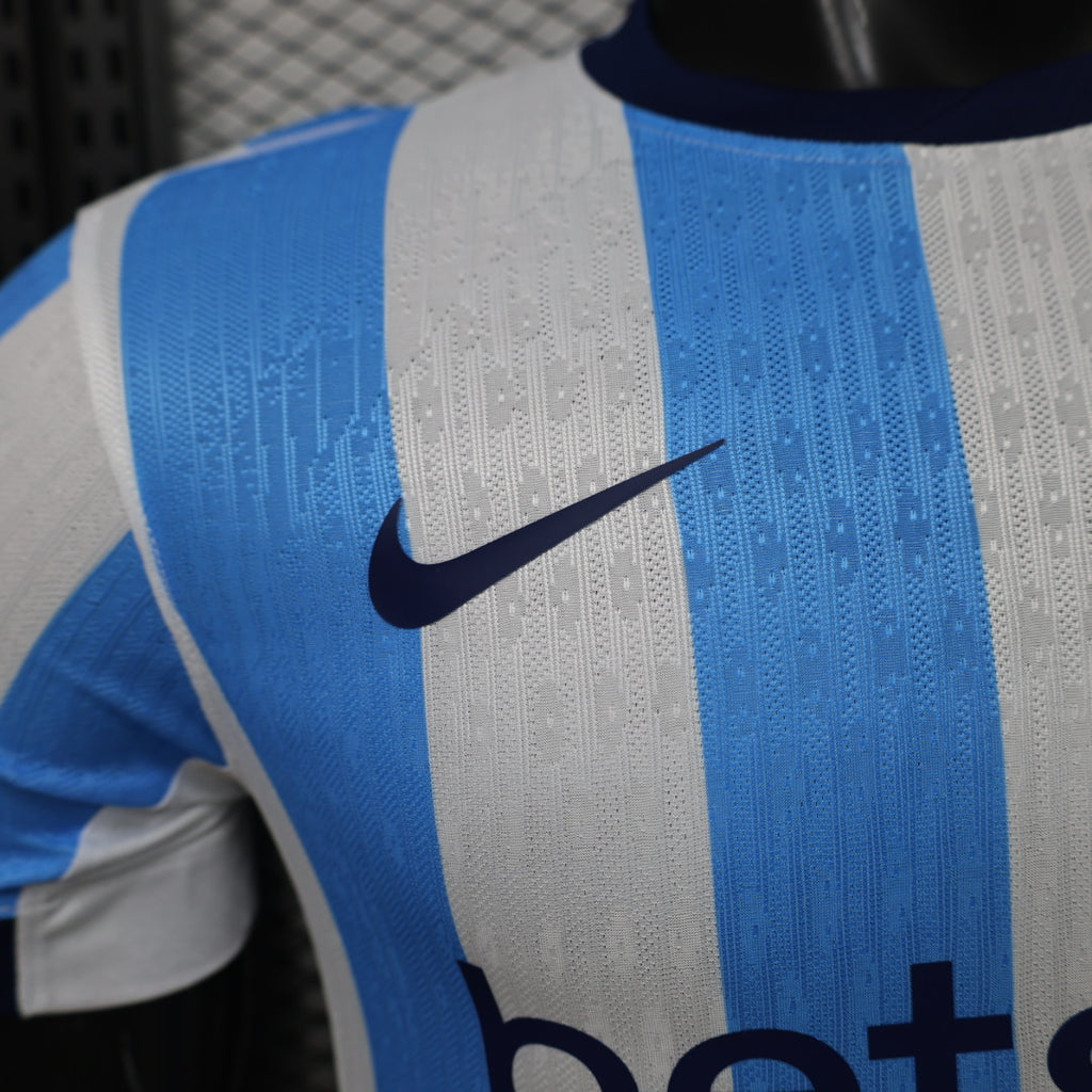 Soccer jersey shoulder with Nike swoosh on blue-and-white striped fabric