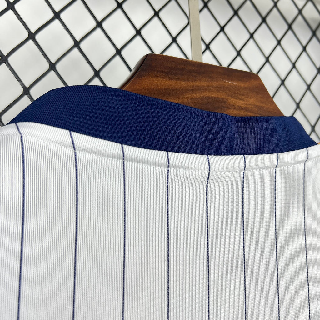 Navy ribbed collar on white pinstripe soccer shirt with textured knit fabric