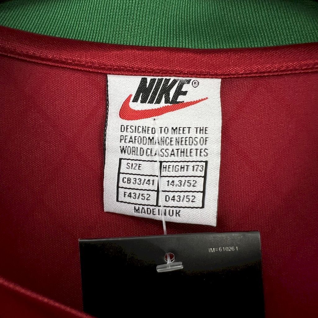 Nike size tag on maroon football jersey with Made in UK label