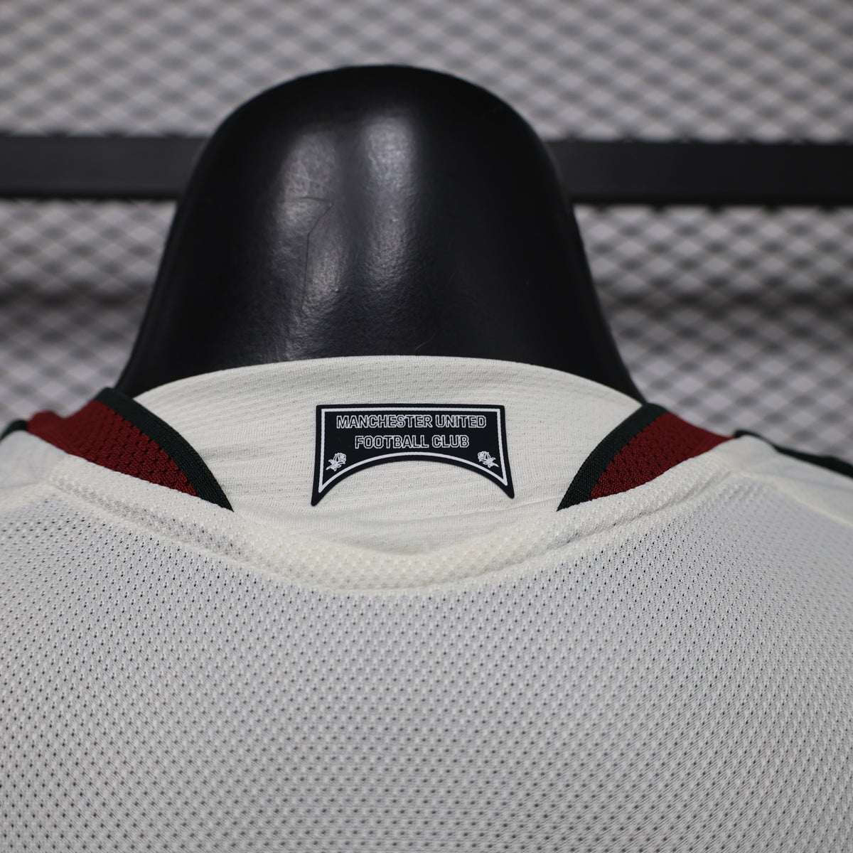 White Manchester United third player shirt collar with maroon trim and club label