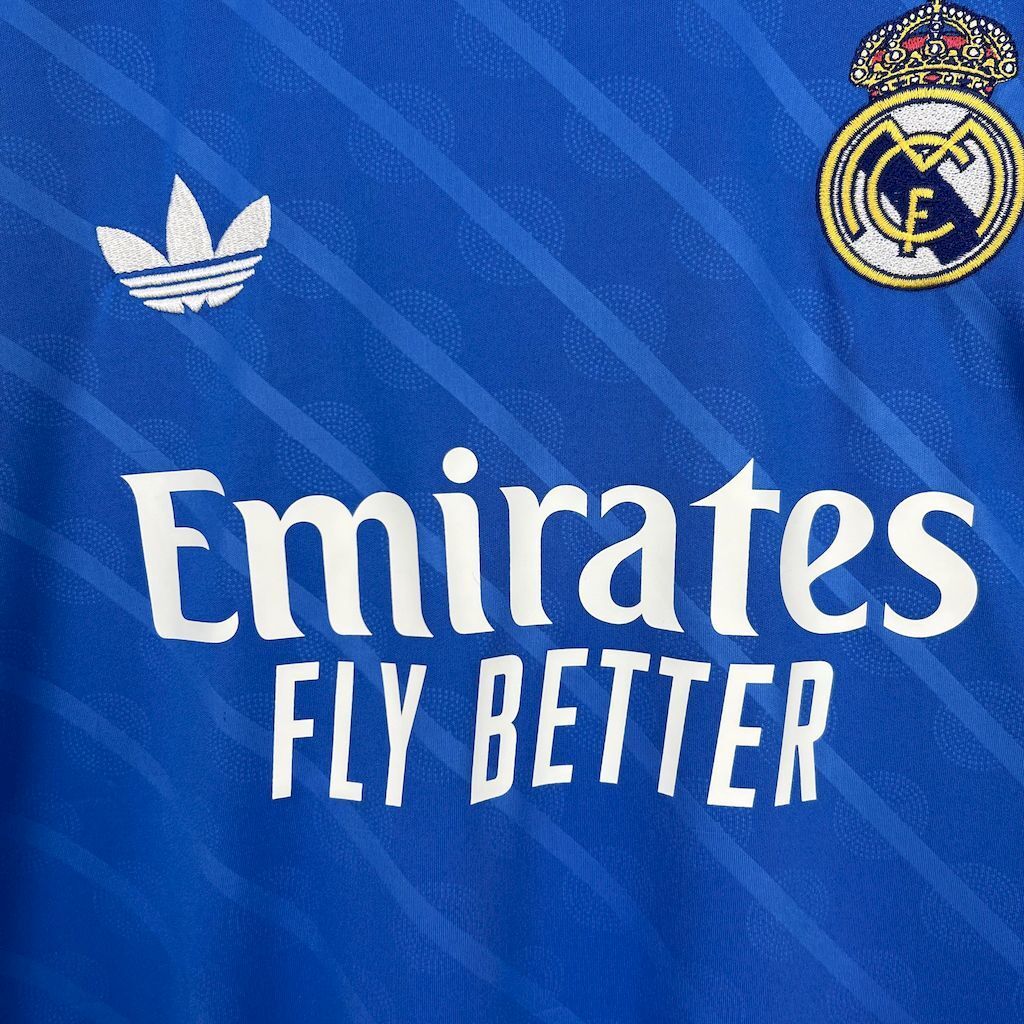 Real Madrid jersey front close-up with Emirates Fly Better sponsor in white on blue