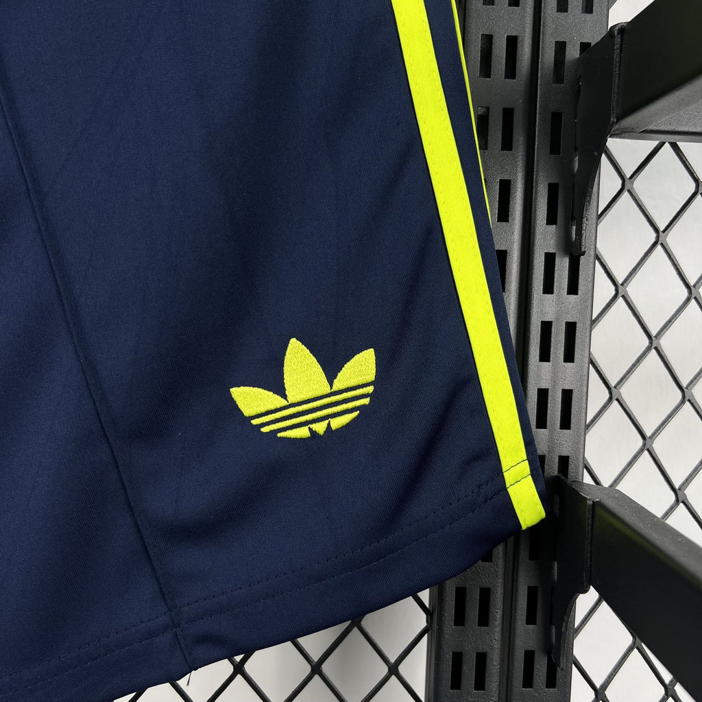 Navy shorts leg with neon yellow adidas logo and side stripe
