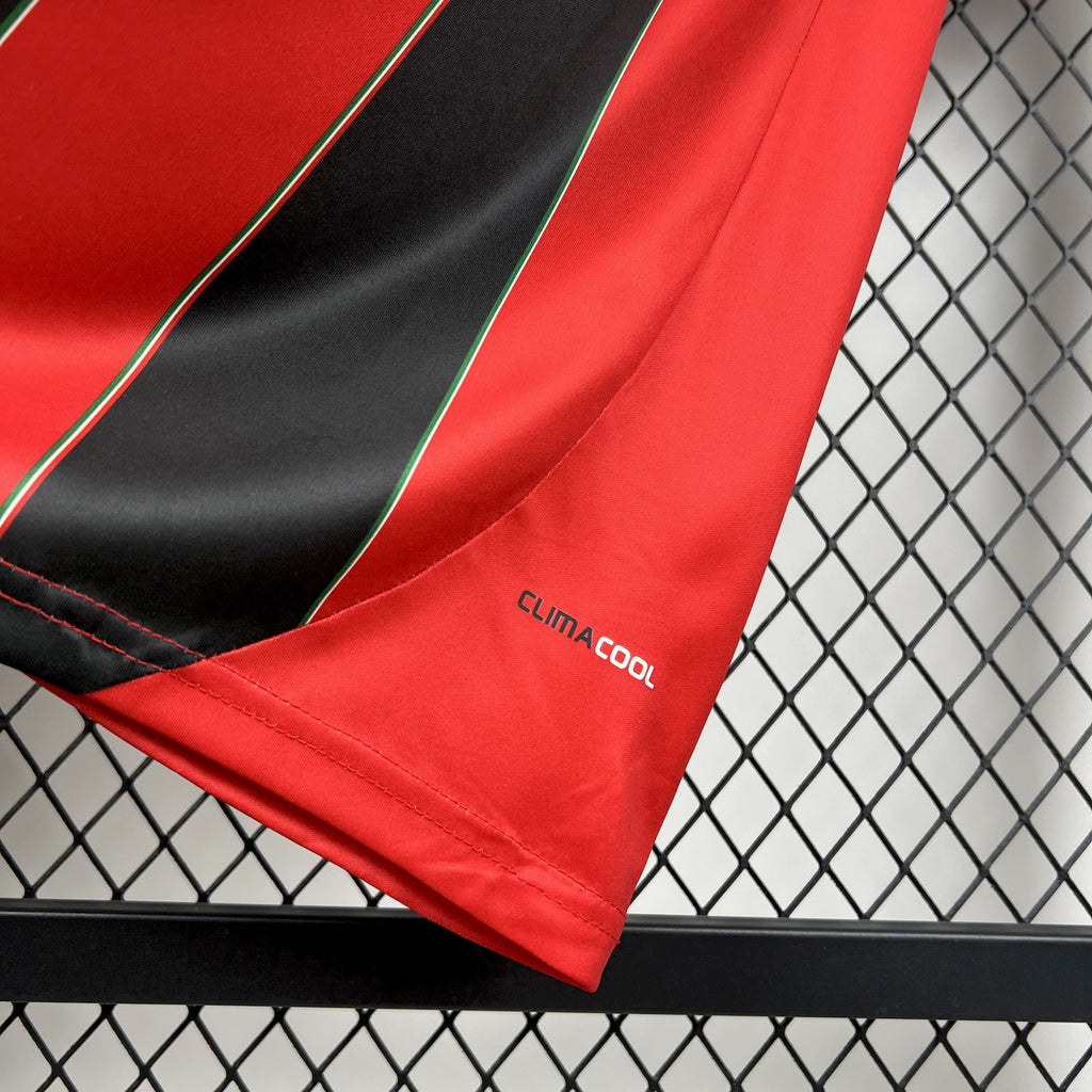 Red soccer jersey sleeve with black stripe trim and climacool label
