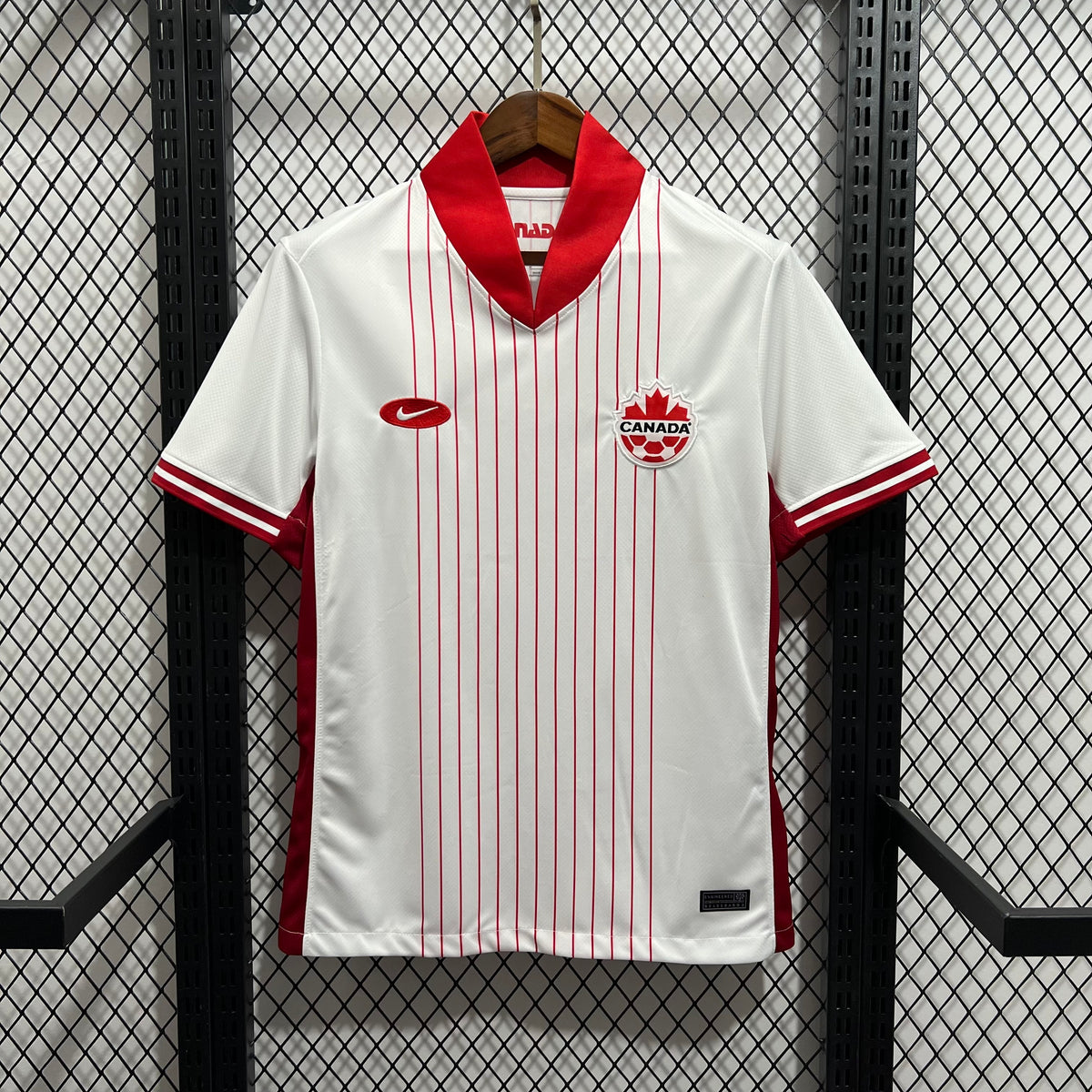 White soccer jersey with red vertical stripes, red V-neck collar, Canada crest