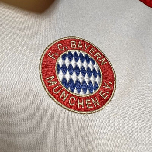 Close-up of Bayern Munich crest on a white third fan jersey
