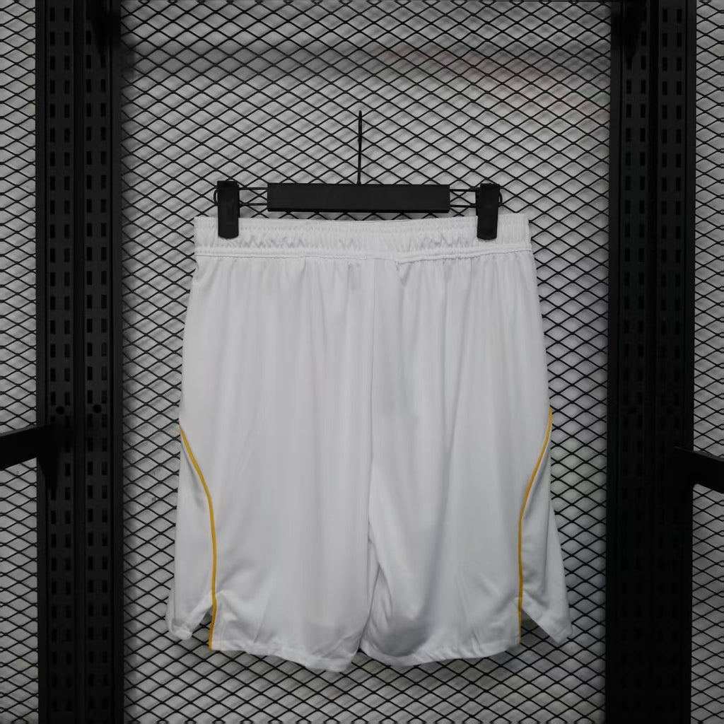 White soccer player shorts with yellow side piping and a smooth back panel.