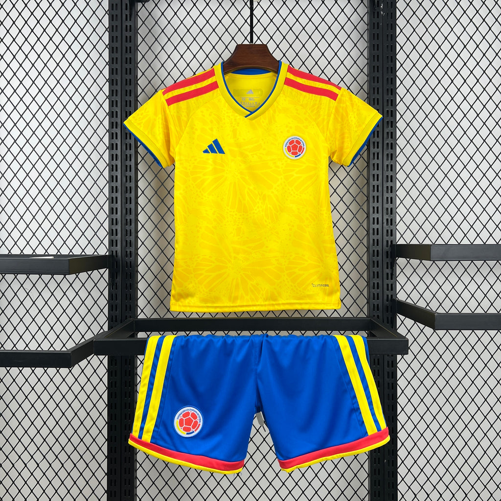 Kid Colombia home soccer kit: yellow jersey with red accents and blue striped shorts