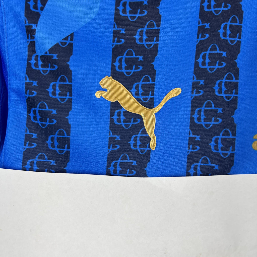 Blue soccer jersey with gold Puma cat logo on vertical stripe panel