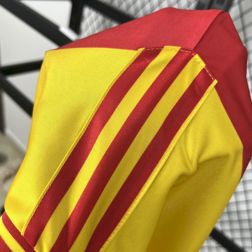 Yellow soccer jersey sleeve with maroon and yellow diagonal stripes panel